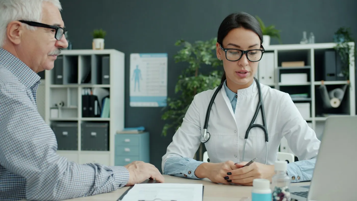 A doctor speaking with an older patient